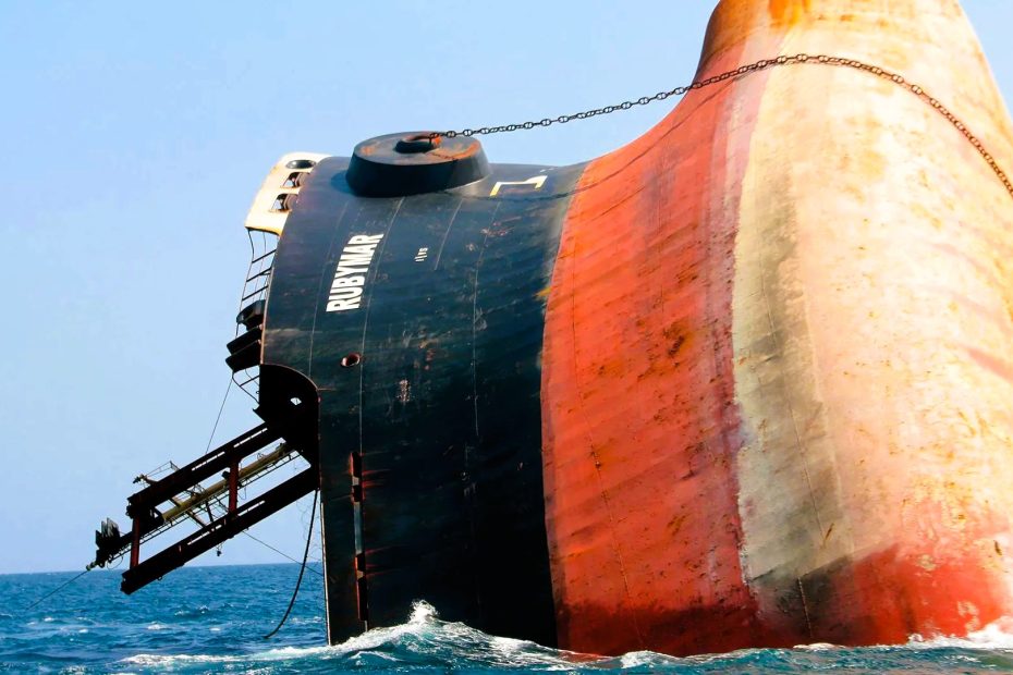 Suez Canal Traffic_geo-trends.eu_A partially submerged cargo ship named Rubymar in the Red Sea, damaged from a missile attack, highlighting maritime conflict and environmental risks