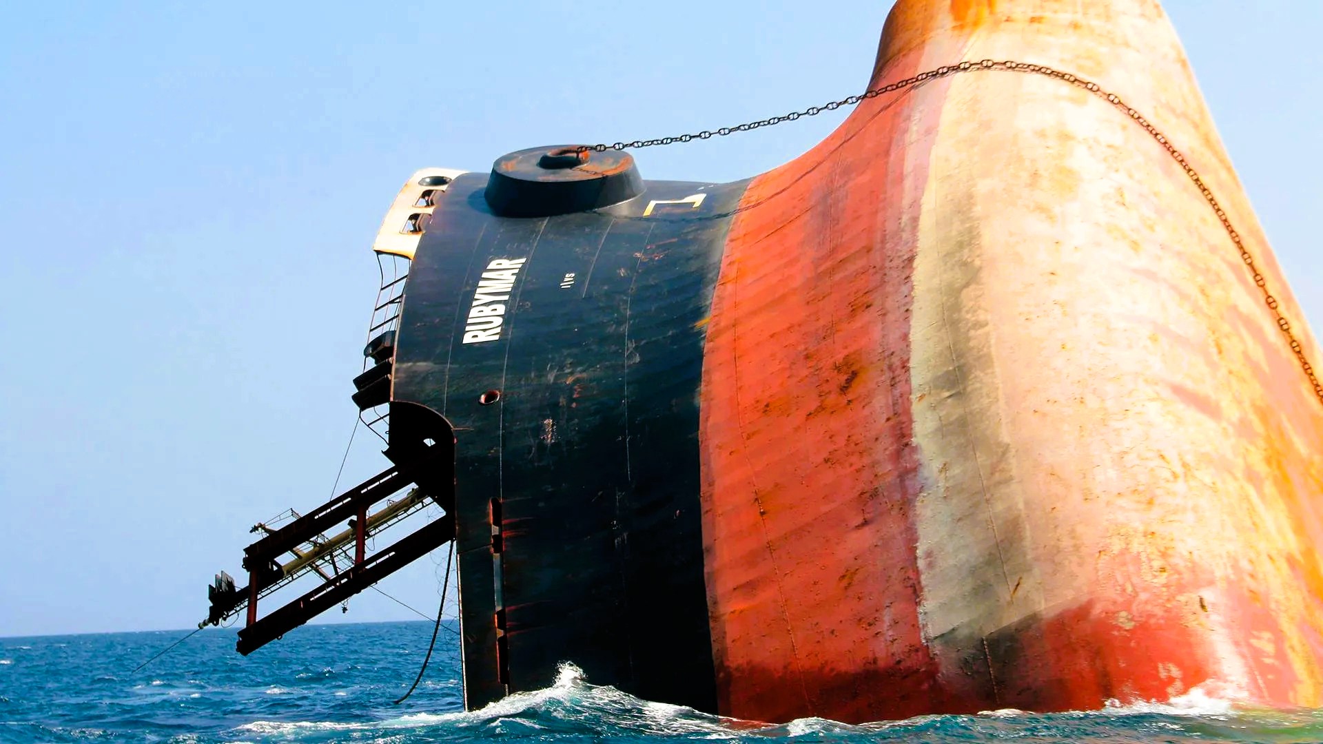 Suez Canal Traffic_geo-trends.eu_A partially submerged cargo ship named Rubymar in the Red Sea, damaged from a missile attack, highlighting maritime conflict and environmental risks