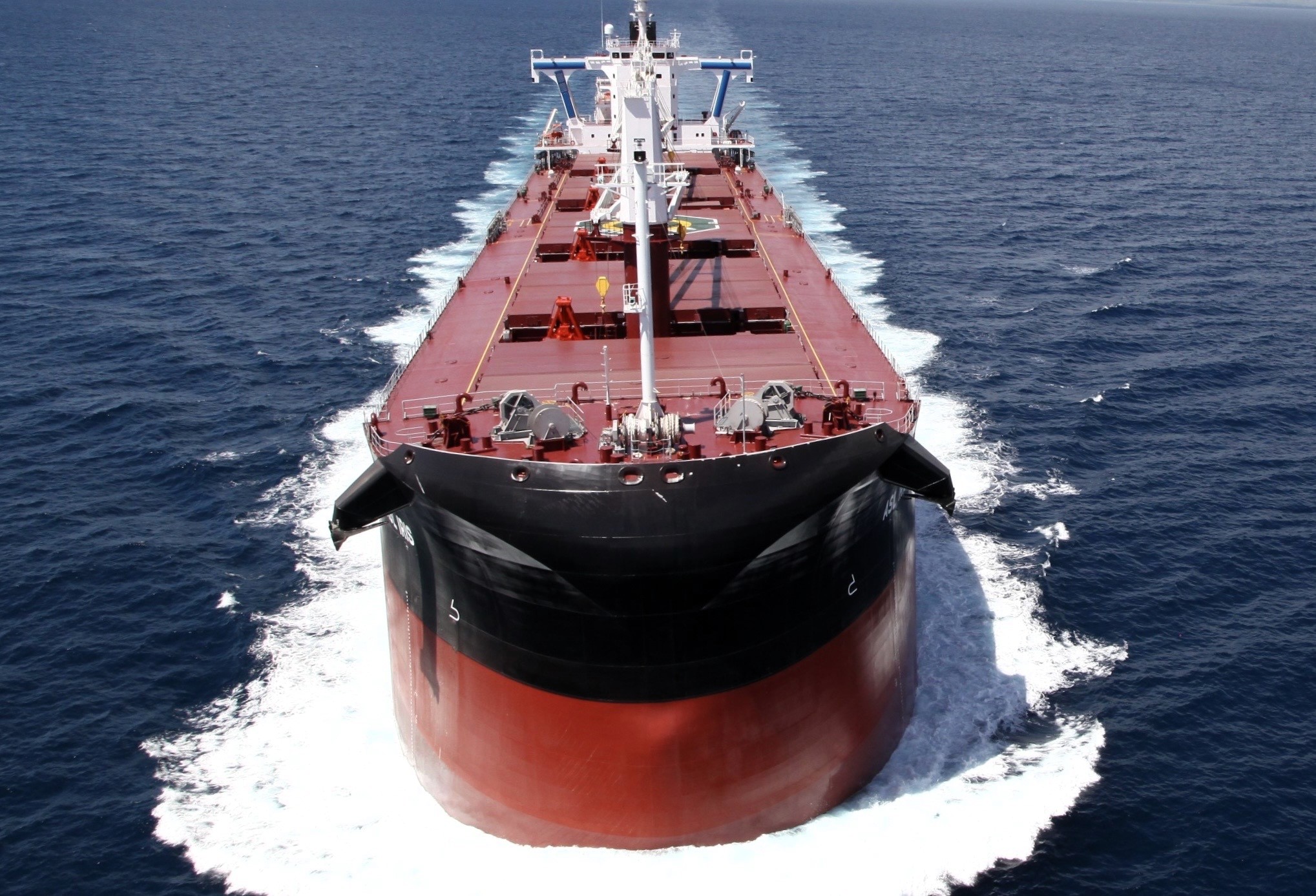 An Ultramax vessel sailing through turbulent waters, symbolizing the volatility and market pressures in the global shipping industry