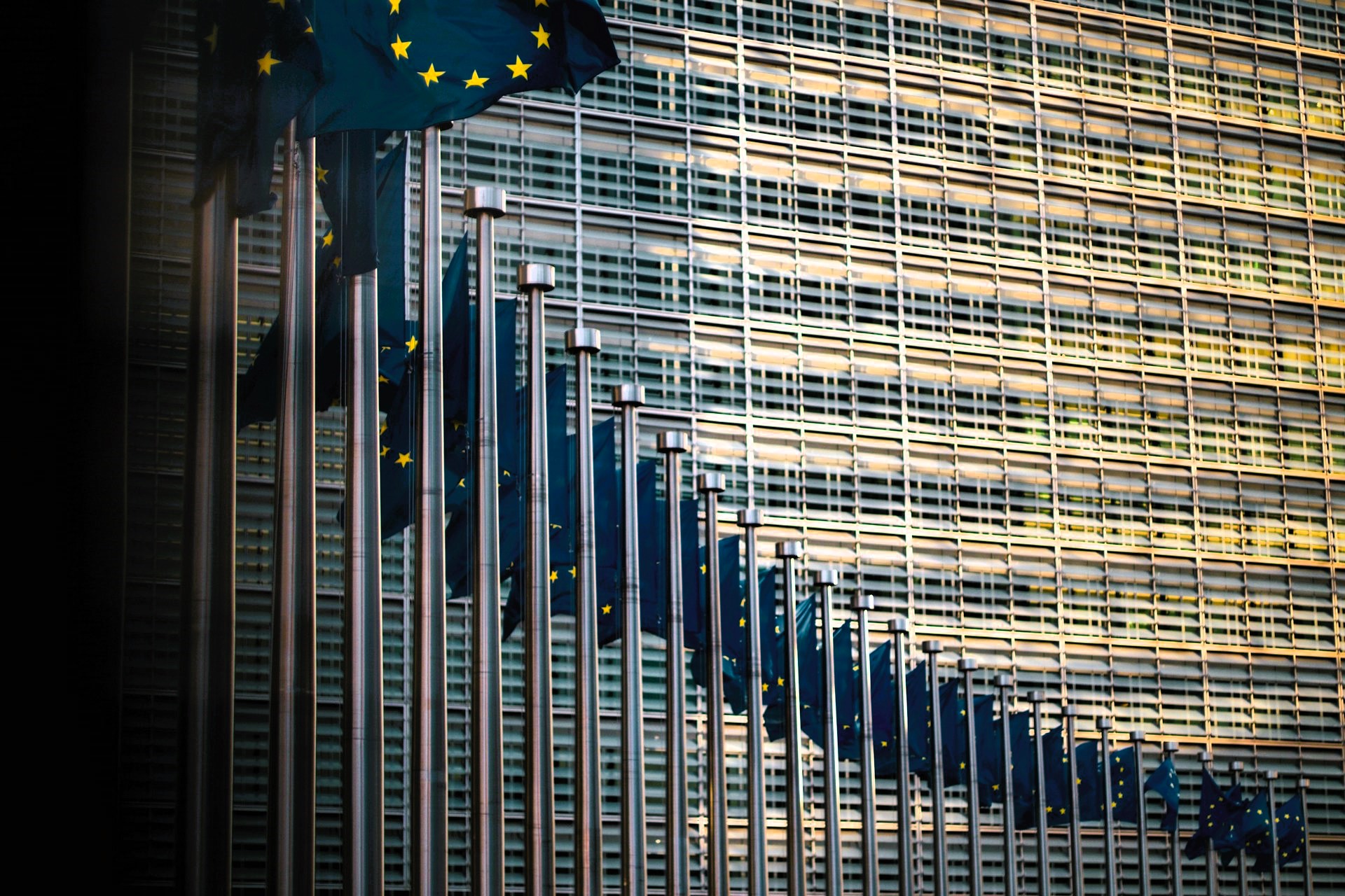Flags of the member states of the European Union in front of the EU Commission building “Berlaymont” in Brussels, Belgium, symbolizing the unity and complexity of European governance