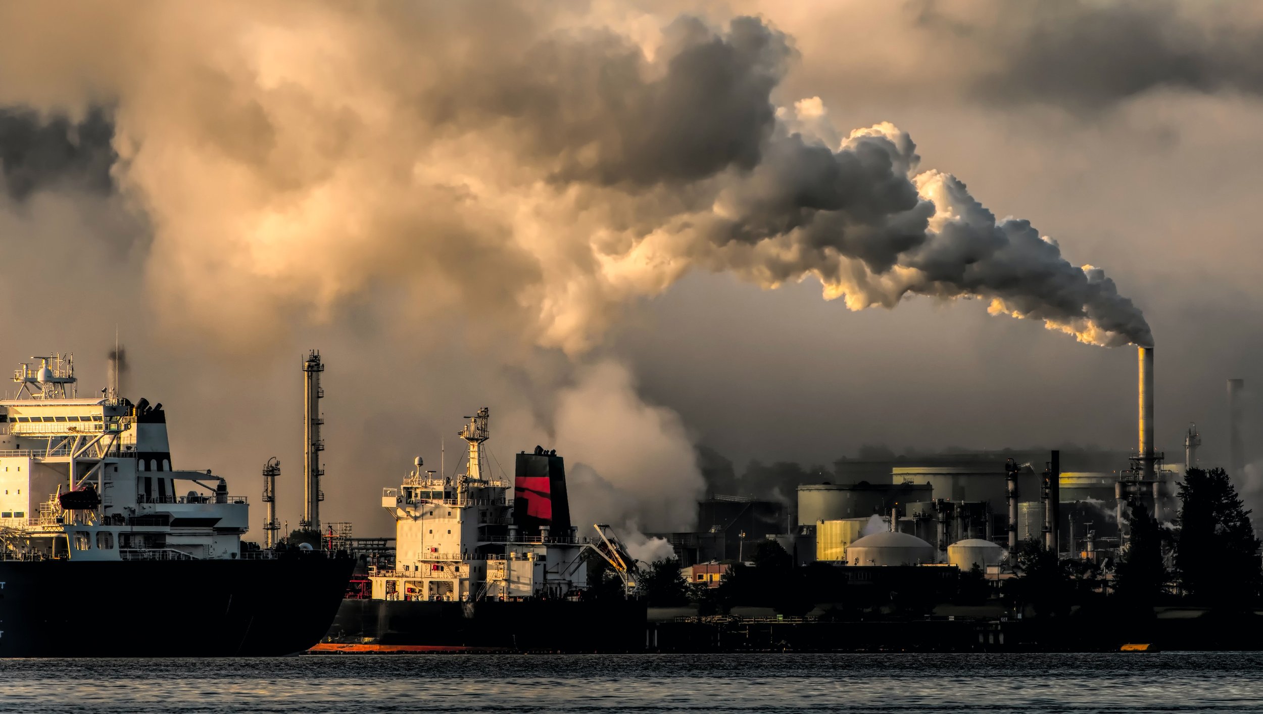 Industrial cargo ships and oil refineries fill the sky with dense smoke, symbolizing the environmental toll of abandoned climate policy in maritime trade