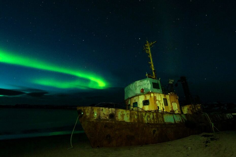Abandoned ship under the Northern Lights, symbolizing transformation and change in maritime markets