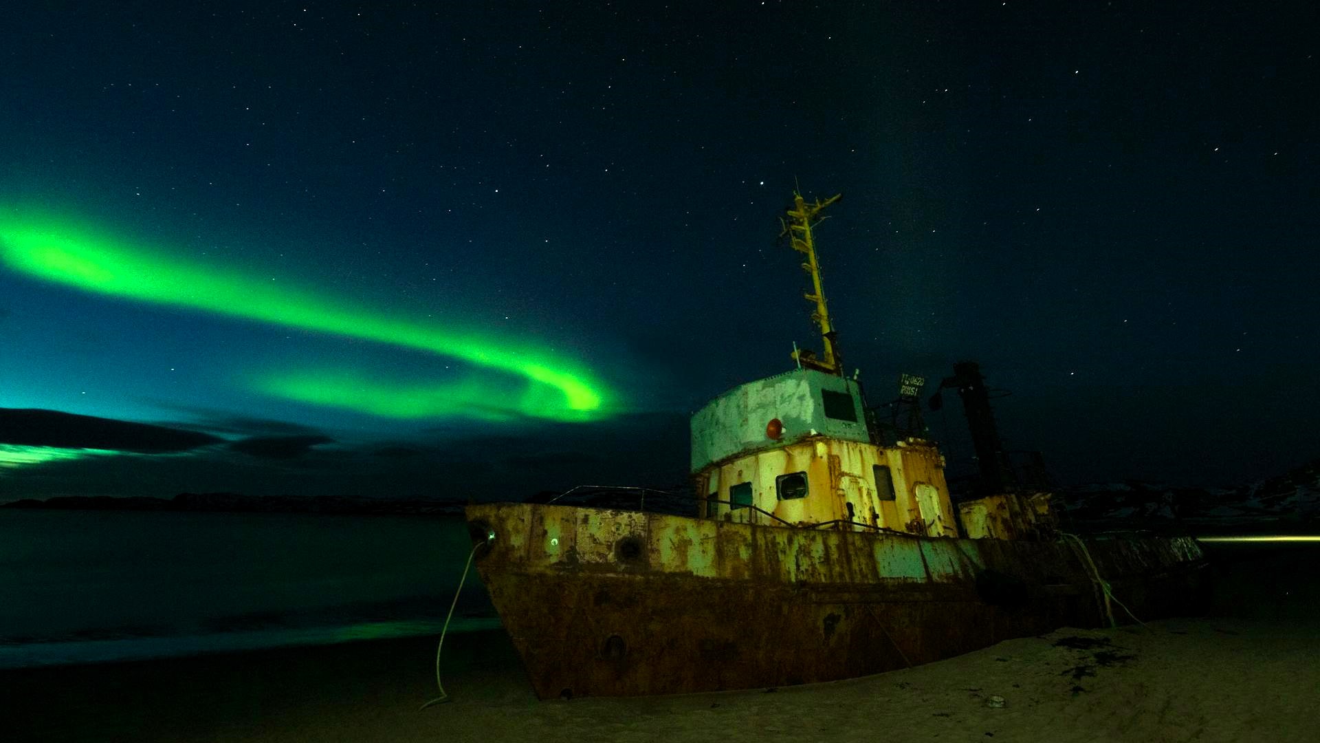 Abandoned ship under the Northern Lights, symbolizing transformation and change in maritime markets
