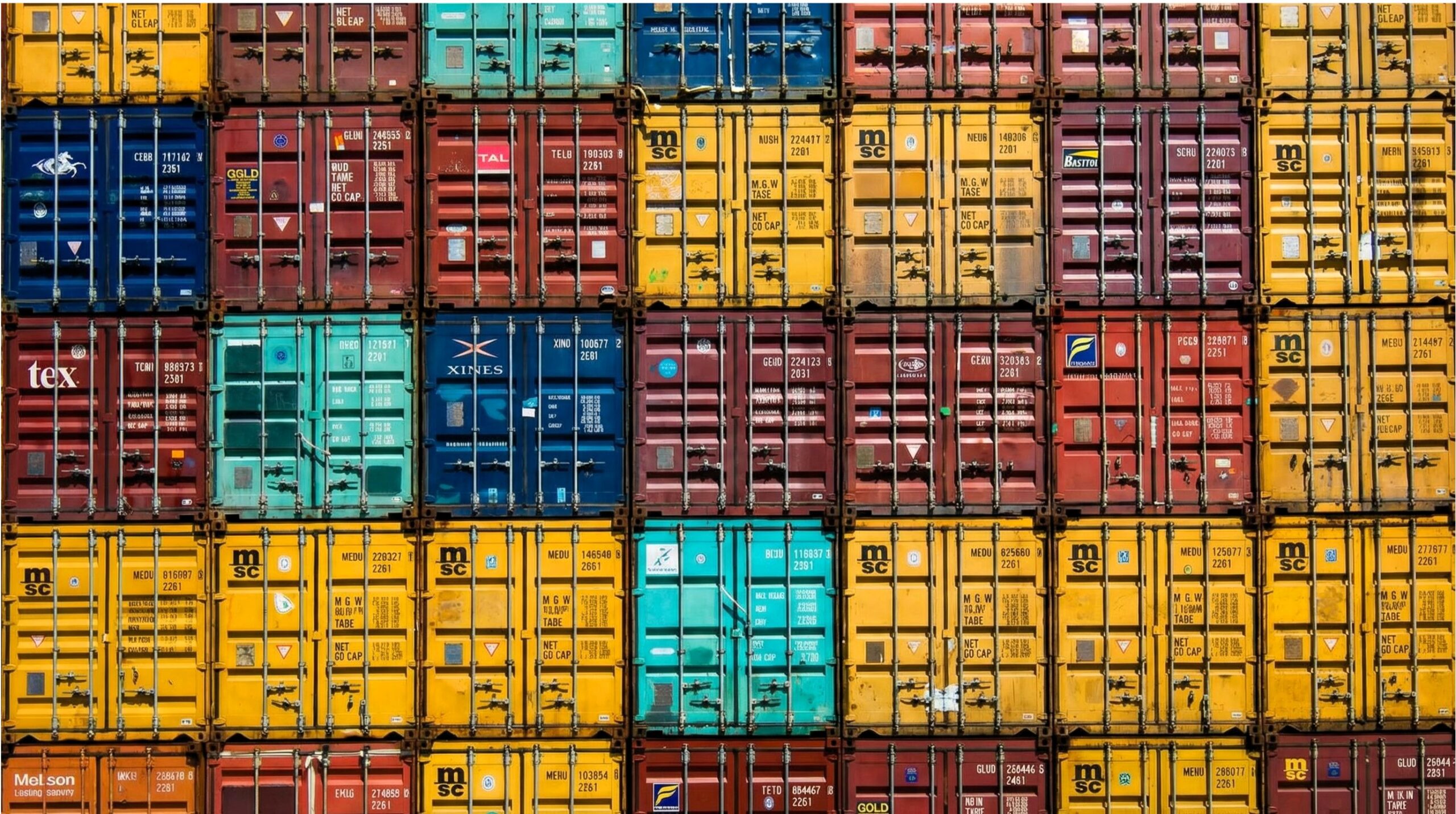 Stacked shipping containers bearing leasing company prefixes—Florens FSCU, Beacon, Matson Leasing, and Textainer—at a container terminal, illustrating the hidden ownership structure of global trade