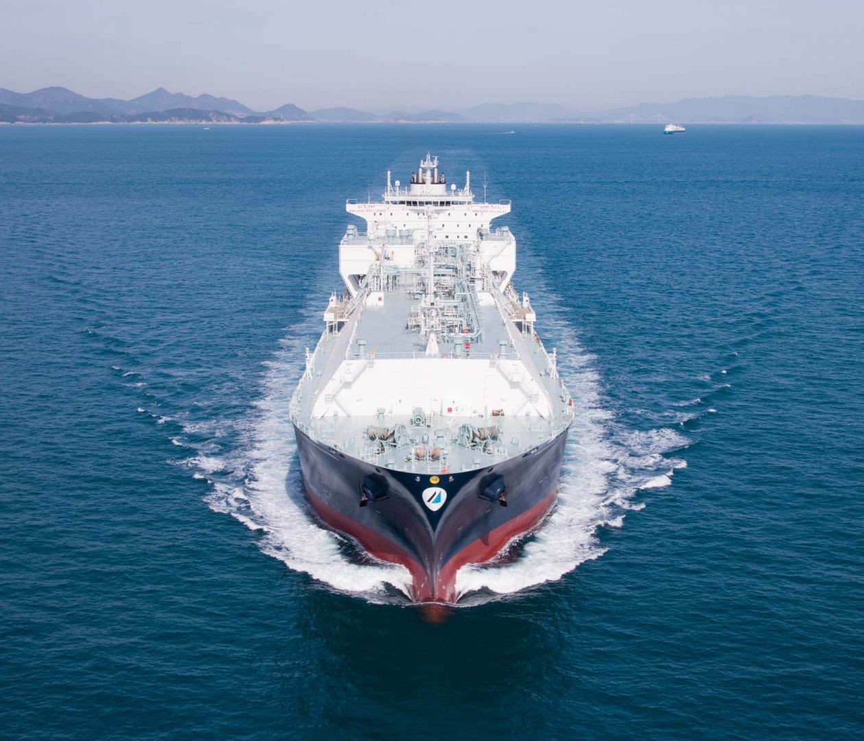 Front view of the LNG carrier Minerva Chios sailing at sea, with visible deck piping, membrane cargo system, and surrounding calm waters
