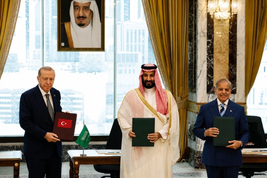Erdoğan, Mohammed bin Salman and Sharif holding signed copies of the Mecca Pact in Mecca, Saudi Arabia