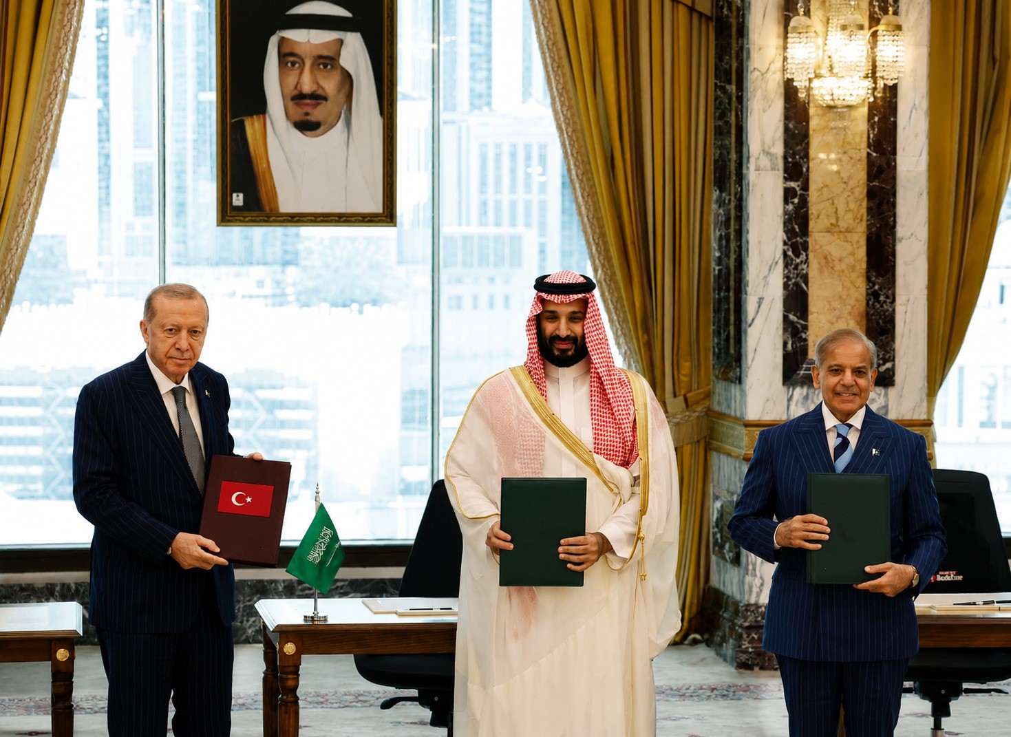 Erdoğan, Mohammed bin Salman and Sharif holding signed copies of the Mecca Pact in Mecca, Saudi Arabia