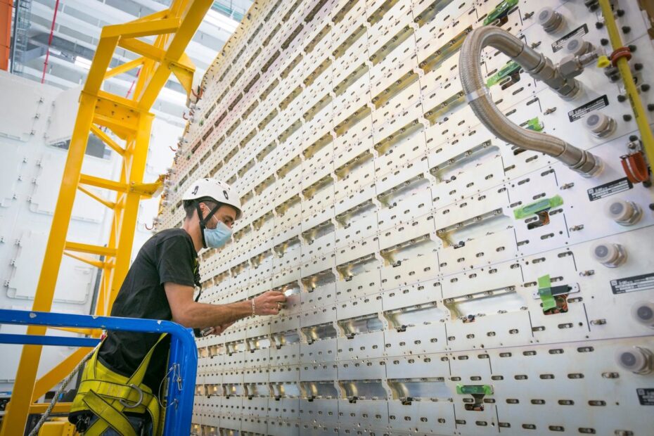 Technician working on a large precision-engineered industrial structure, illustrating advanced manufacturing capabilities and technical expertise in aerospace production